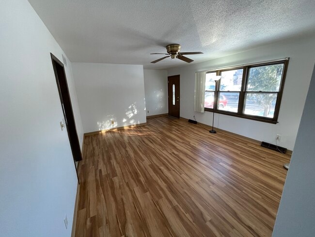 Living room, with large window, looking at front door. - 715 Westgate St Condo Unit Main Level