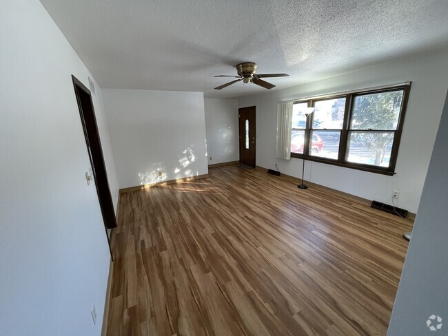 Living room, with large window, looking at front door. - 715 Westgate St Unit Main Level Rental