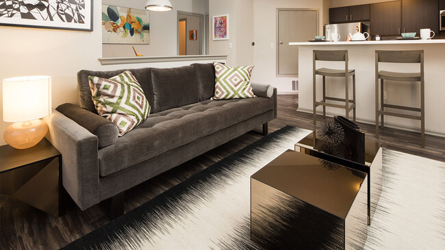 Apartment Living Room with wood floors. - Griffis Lafayette Station Apartments