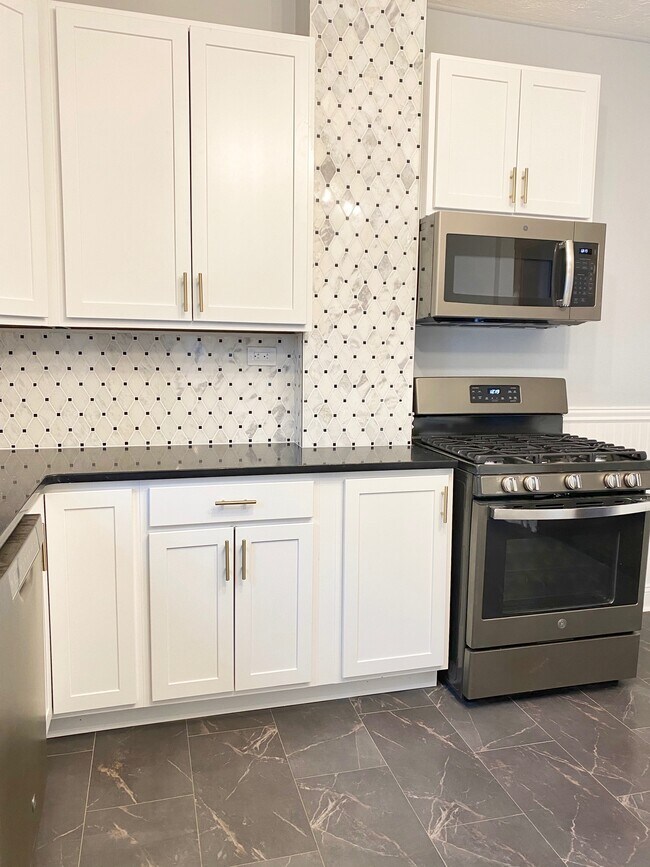 New white shaker cabinets with soft close and champagne bronze hardware - 1346 Edwards Ave