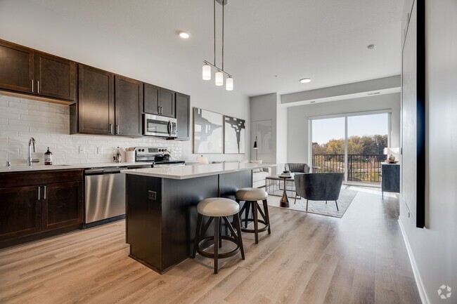 Enjoy the elegance of our kitchens with dark cabinetry and modern finishes. - Aspire at CityPlace Rental