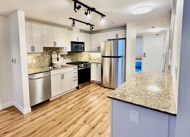 After renovation, modern sleek kitchen with brand new oven. - 1240 India St Unit 1906