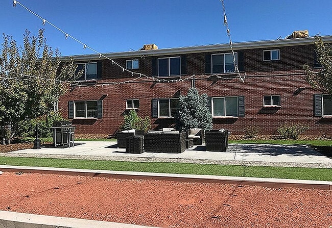 Enjoy outdoor living in this charming apartment setting, complete with cozy seating and beautiful landscaping. - Wadsworth Station West