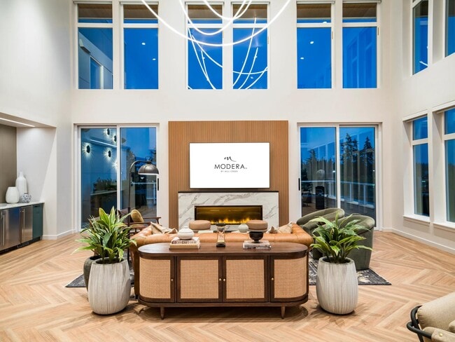Expansive windows and refined finishes make Modera Shoreline’s lounge a bright, welcoming retreat perfectly suited for gatherings or quiet evenings in.