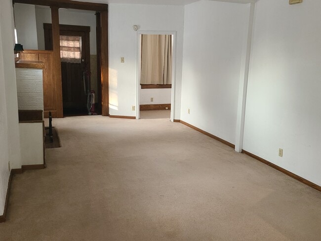 Looking towards front door. Fireplace on left. - 122 Edgerton Rd Unit Edgerton first floor