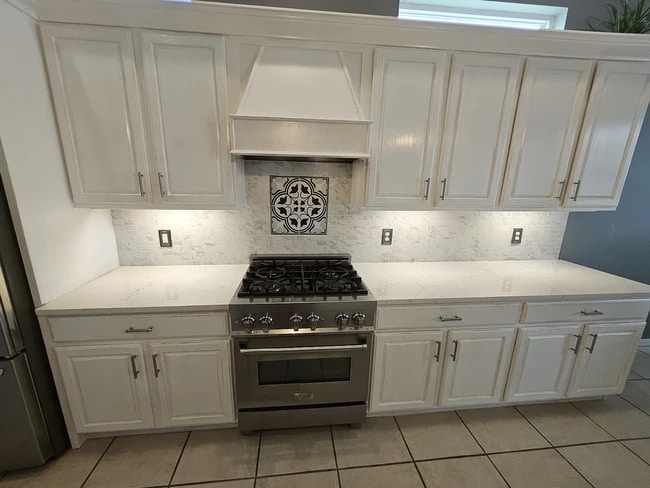 Custom renovated kitchen with a curved quartz countertop and new appliances - 4353 Reflections Pky