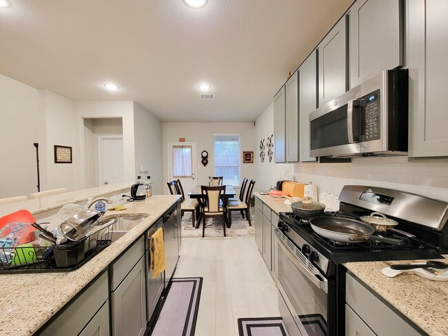 Photo - This stunning 2-year-old house with 4 beds, 3 baths, and an attached 2-car garage, it offers ampl...