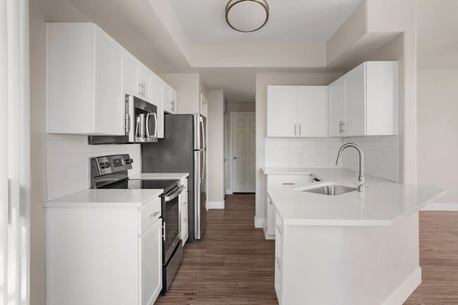 Kitchen area that leads to a spacious balcony with its own storage close