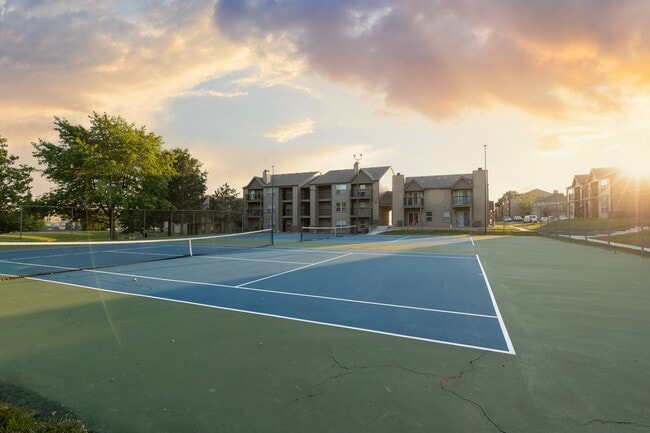 Ace your game at The Lakes community tennis courts, with stunning views of the apartment buildings in the background!
