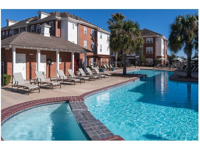 Relax and unwind by the resort-style pool at The Quarters, your perfect off-campus housing near UL Lafayette. - The Quarters Apartments