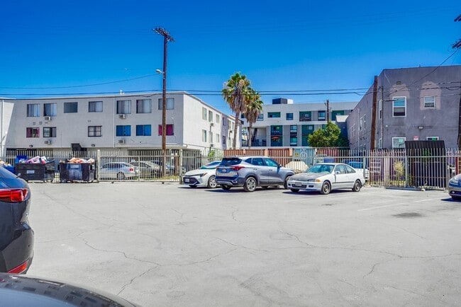 Parking lot - Charming Courtyard Apartments in West Adam...