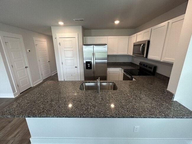 Photo - Welcome to this brand new end unit townhome that combines modern convenience with style and charm...