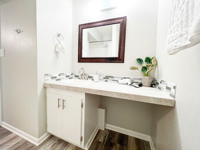 Luxury awaits in this renovated bathroom with tile finishes and new sink. - 2125 Banita St Apartments Unit 1