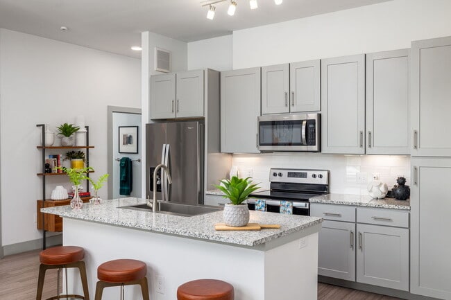A kitchen island back here holds the food while you cook along the wall.