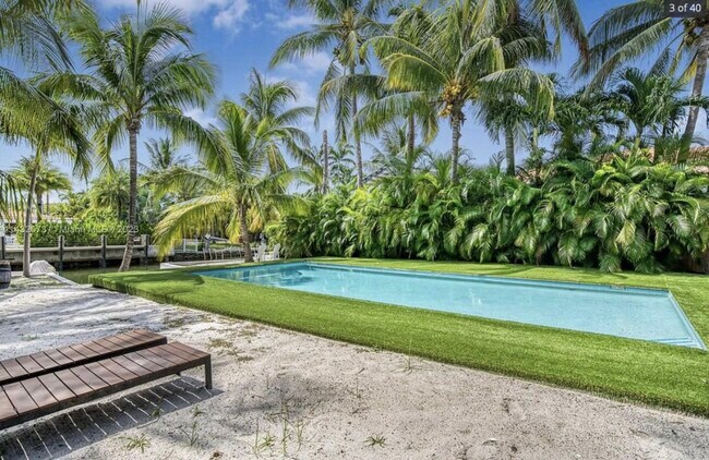 Tropical garden with canal front view - 7960 Hawthorne Ave