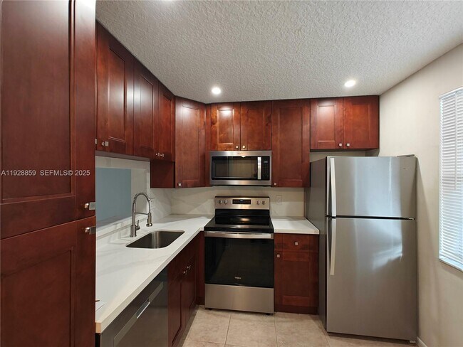 Building Photo - 8770 Royal Palm Blvd Unit 203-2