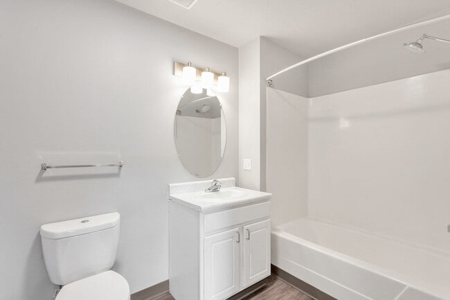 Comfortable bathrooms feature a full tub and shower combination with modern fixtures, professionally managed by Highlands Vista Group.