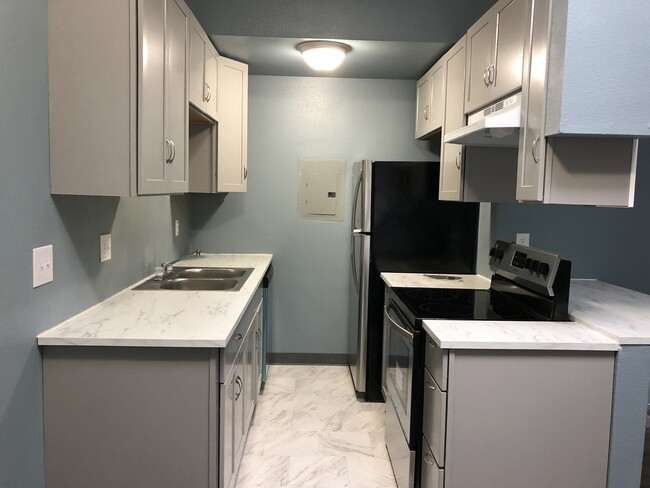 Brand new stainless steel appliances with open seating bar-perfect for meals or a desk. - 219 36th E St Apartment Unit A