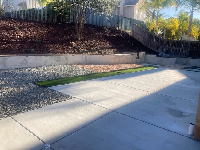 Newly renovated backyard with fencing and hardscape that is ideal for pets!