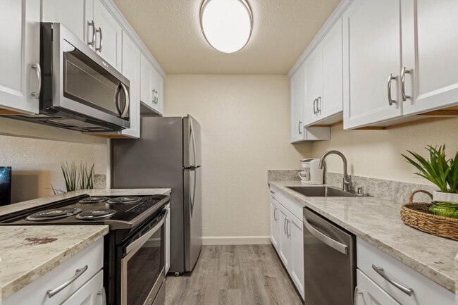 Deluxe Kitchen with Soft close Cabinets, Sleek Stainless Steel Appliances, & Granite Countertops - Aggie Square Apartments