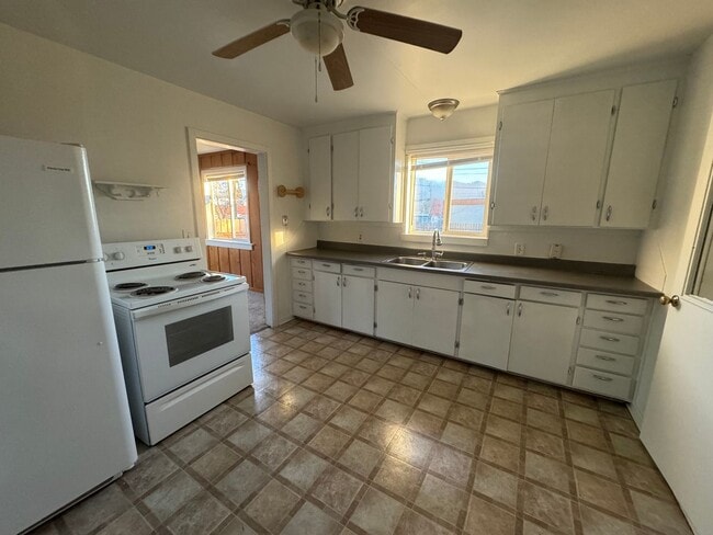 Photo - House with garage, carport, yard, & shed