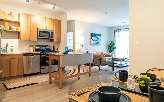 Connected Kitchen and Living Area with Island Cart and Dining Setup - The Madison at Marshfield Rental