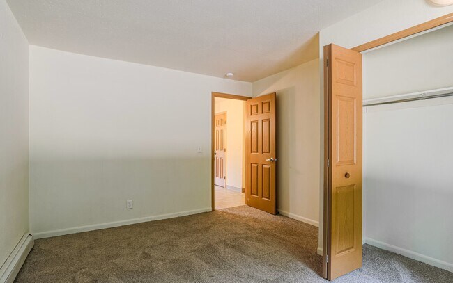 Bedroom, with closet and view to hallway.