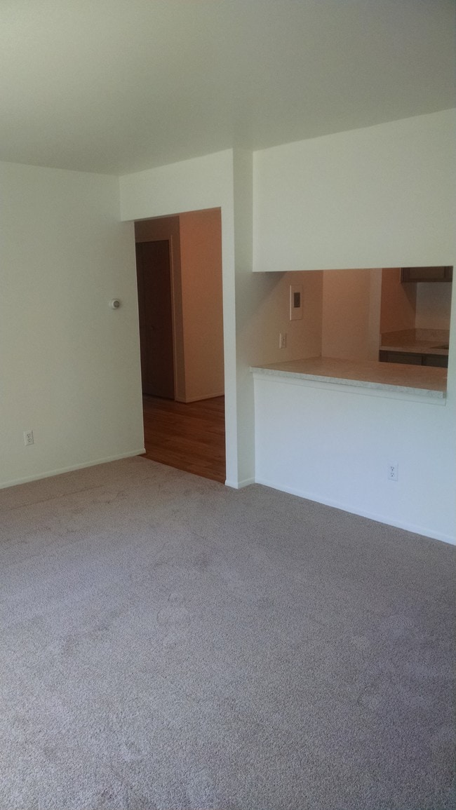 Living Room, looking into Dining Room - Pinecrest Apartments