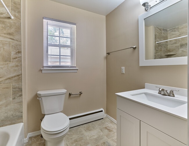 Freshly updated bathroom with clean tile finishes and modern vanity at Maple Terrace Apartments in Maple Shade, NJ