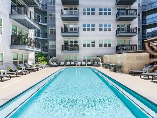 Soak up the sun or cool off in the crystal-clear pool—this courtyard oasis is your personal retreat, perfect for relaxing or entertaining. - Modera Falls Church Rental