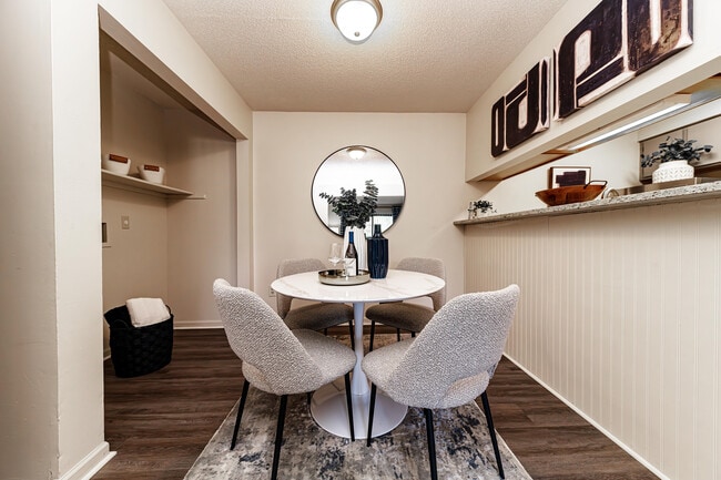 Dining area with hardwood-style flooring and overhead lighting