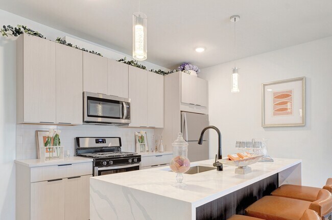 2 BR Kitchen with waterfall island and pendant lighting