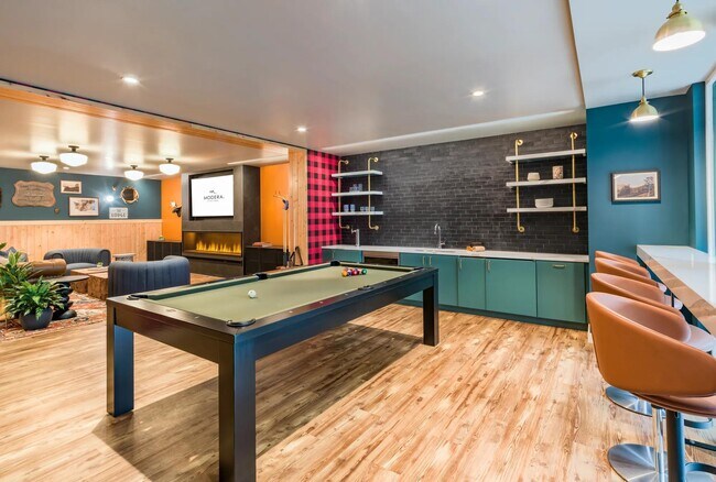 Relax in the lodge lounge with a wet bar, shuffleboard, board games, and foosball. - Modera Northgate