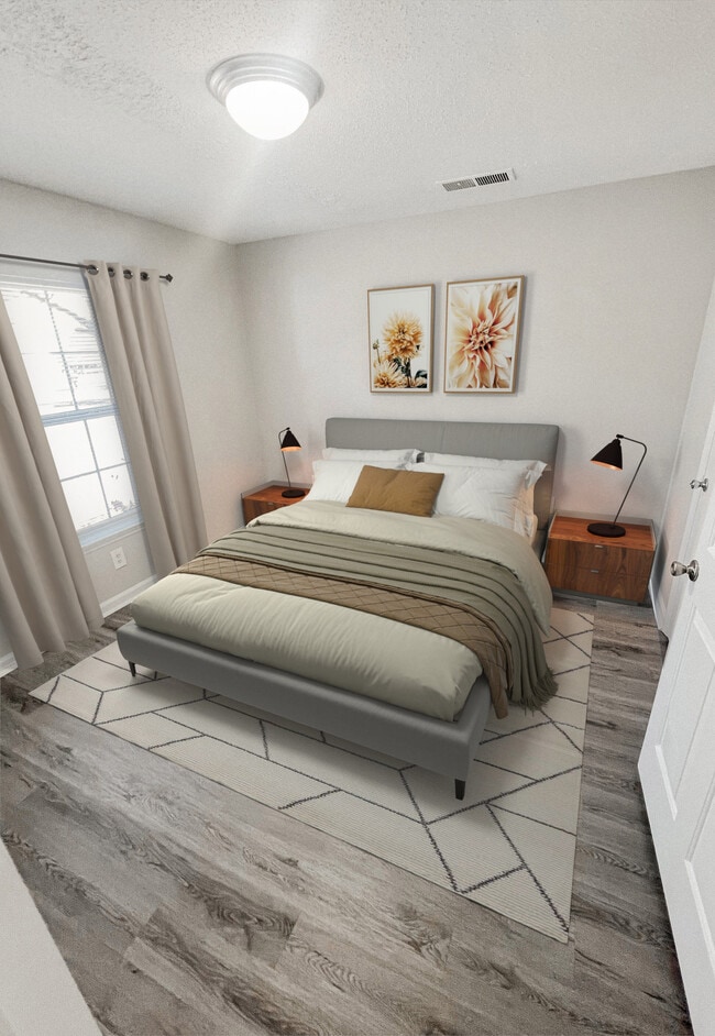 Bedroom with upholstered bed, nightstands, table lamps, decorative wall art, area rug, and wood look plank flooring