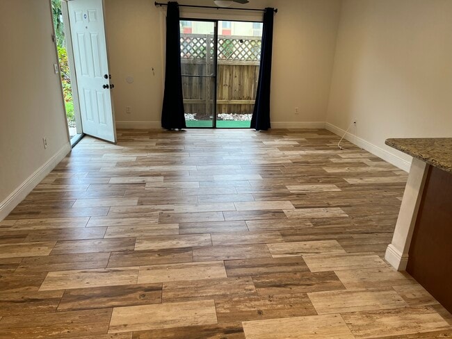 Living room leading to fenced in porch