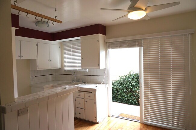Newly tiled kitchen with stove and large sliding glass doors
