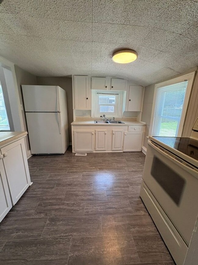 Photo - A cozy 2 bedroom home with versatile living space and plenty of storage including a partially fin...