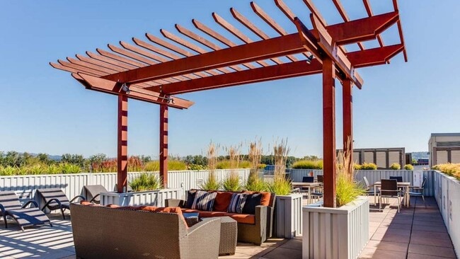 Outdoor rooftop lounge featuring pergola seating and sunbathing areas
