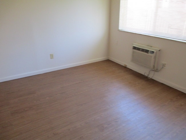 Living Room with vinyl floors - Camelot Apartments