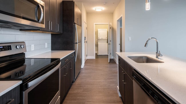 Kitchen with Stainless Steel Appliances and In-home Washer and Dryer