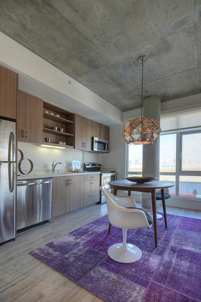 Stylish kitchen with stainless steel appliances and quartz countertops - The Gantry Apartments