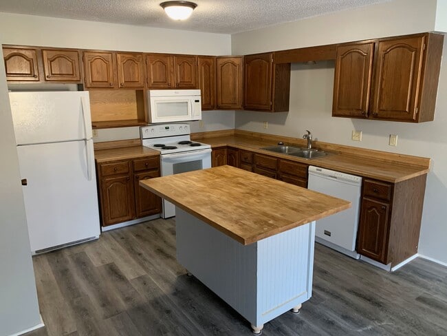 Spacious kitchen with center island and seamless open floor plan—perfect for cooking, entertaining, - 4903 W Kirkwood Cir Townhome