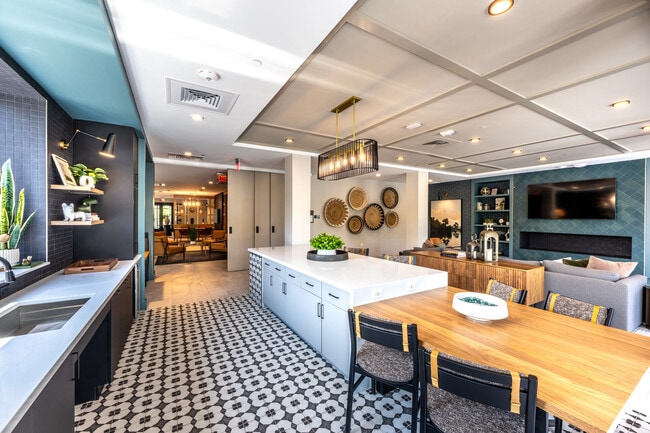 Resident clubhouse lounge featuring a kitchen island and bar seating
