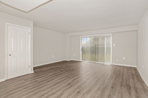Unfurnished living room at The Hills at Milford Mill Apartments in Baltimore, MD