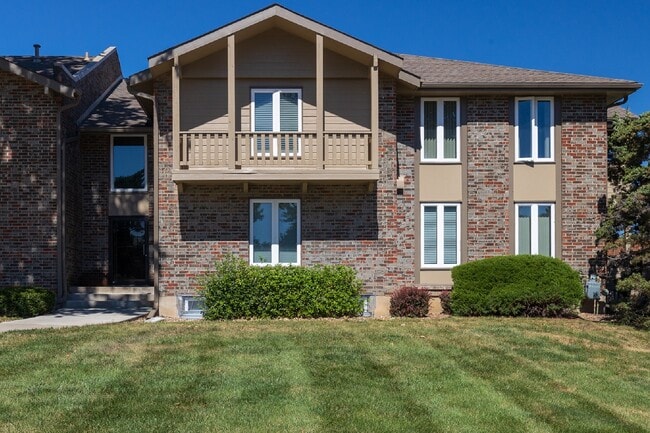 A welcoming community with charming apartment exteriors and green spaces.