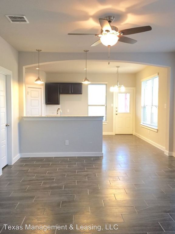 Living area with beautiful tile flooring and kitchen with built-in island. Microwave and dishwasher onsite. - 1010 West Sierra Vista CT Townhome