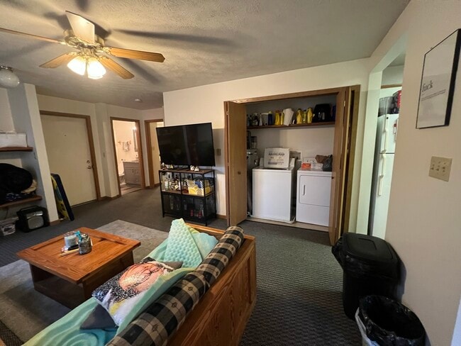 Living room and laundry - 712 McLane Ave Unit Apt. A