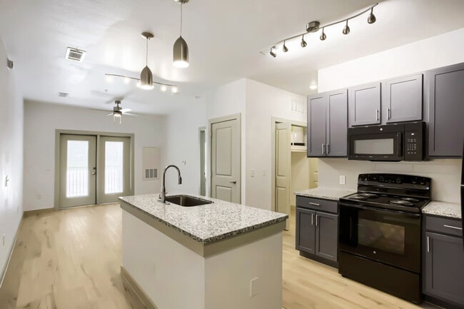 kitchen with island and view of living room - Cleveland Pioneer Crossing