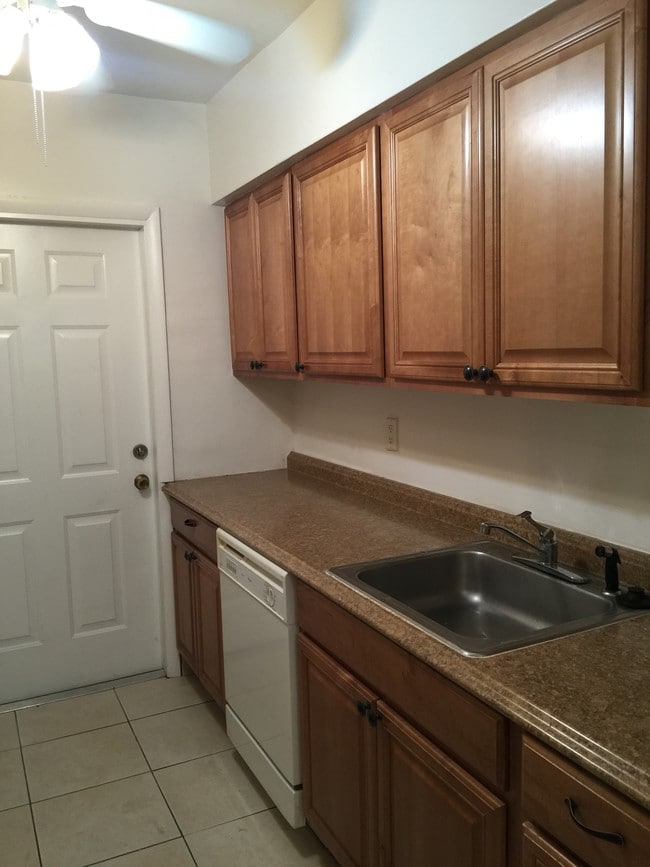 Kitchen now has stackable washer and dryer by door - 265 SW 7th St Unit 2