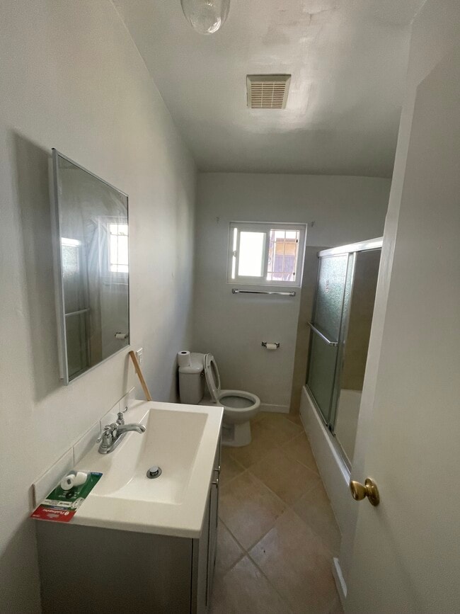 Bathroom with large new vanity and porcelain tile and bathtub - all new fixtures - 10513 Crenshaw Blvd Unit 10513 Crenshaw Blvd #2